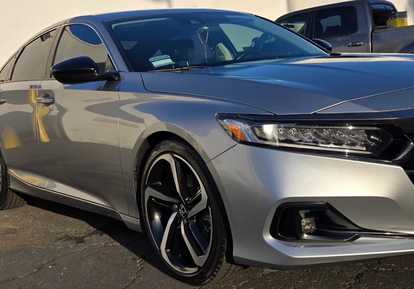 Silver Honda sedan after a hand wash and detail.